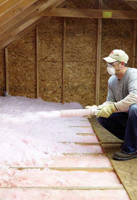 Man Spraying Blow up insulation in the attic